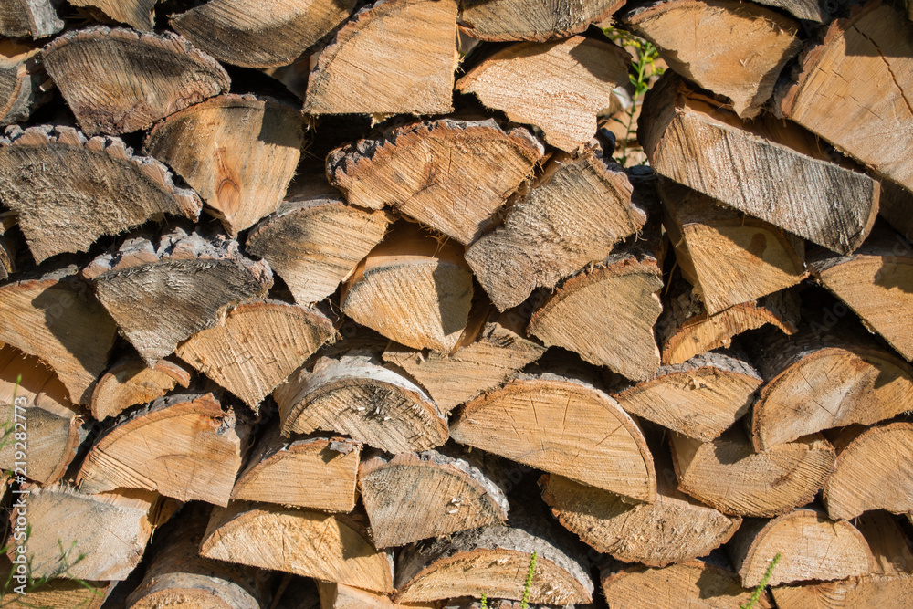 Cut split stacked firewood for winter background close-up