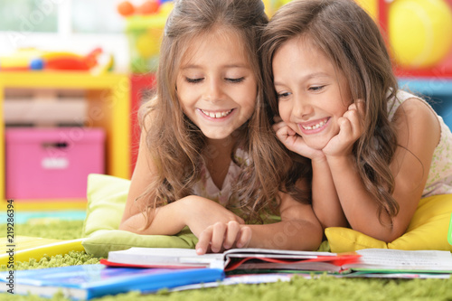 Portrait of two beautiful little girls studying