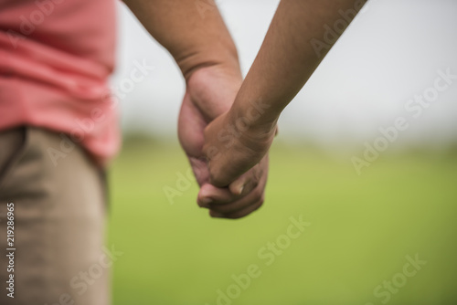 Father and daughter holding hand in hand together