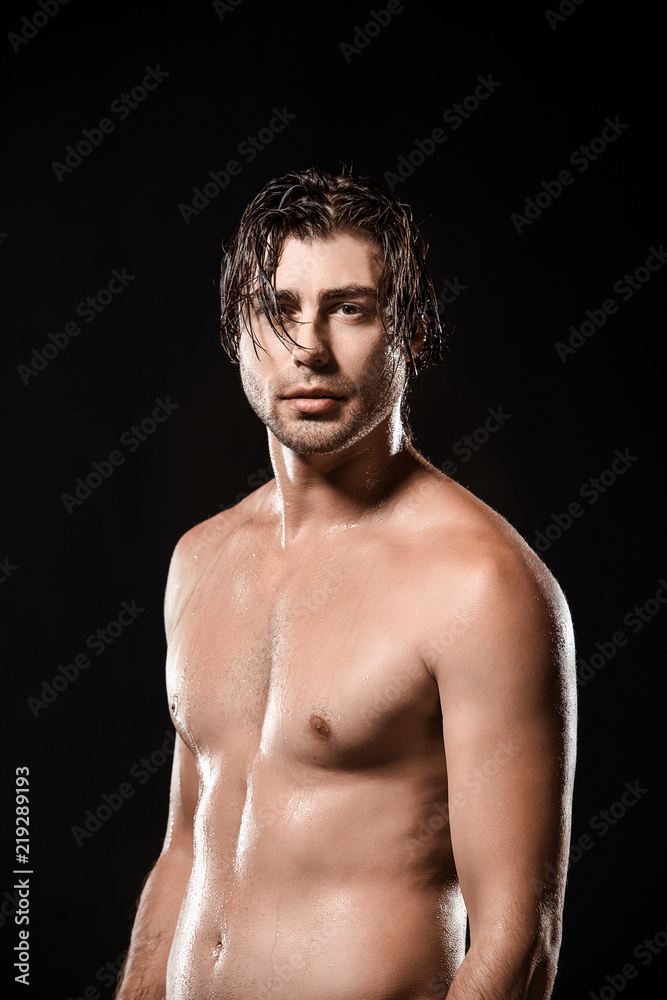 portrait of shirtless man with wet hair looking at camera isolated on black portrait of shirtless man with wet hair looking at camera isolated on black