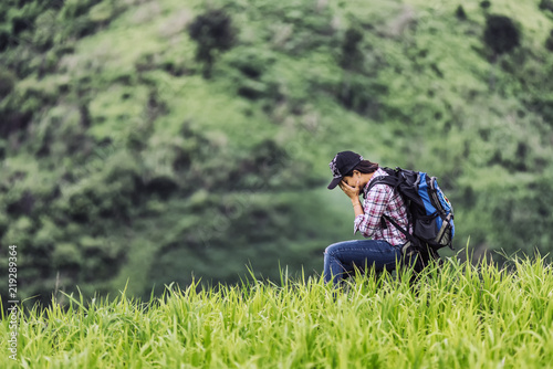 Asian young woman backpack  waiting for help  in the nature rice farmhouse. , her is feeling sorry and have hopefully someone will help her  travel concept. © analysis121980