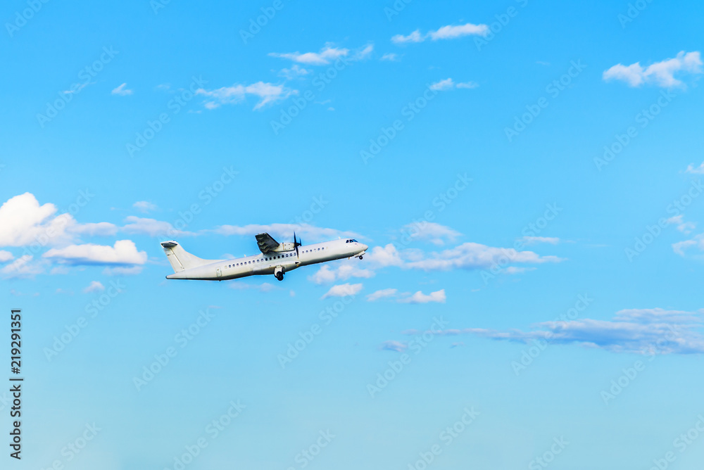 Naklejka premium Flying airplane on blue sky