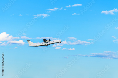 Flying airplane on blue sky