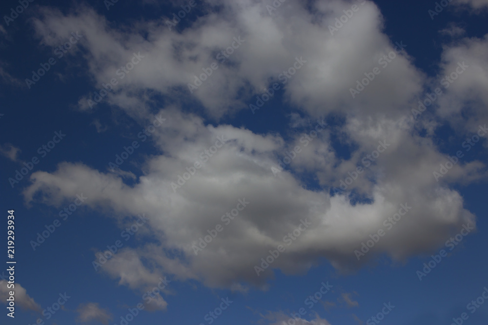 View on beautiful white and gray clouds in a blue sky.