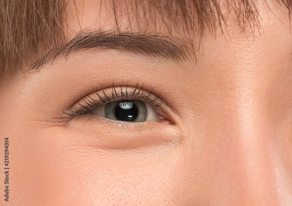 Obraz premium The close up gray eye on face of young beautiful caucasian girl