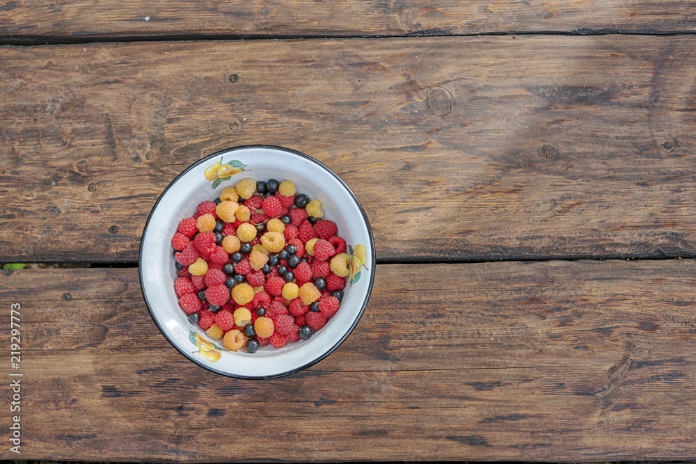 Big Pile of Fresh Raspberries in the wooden Bowl Big Pile of Fresh Raspberries in the wooden Bowl
