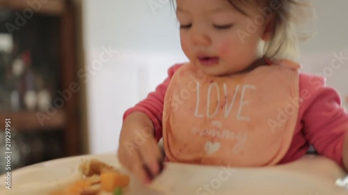 Little Girl Doing Sign Language while Eating Blackberries photo