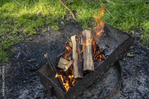 Flame of wood burning in brazier during the preparation for cooking BBQ.