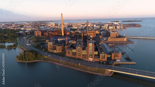 4K Aerial scene with sea, bridge, cars, power plant and sun reflections on a summer evening at sunset. Länsiväylä, Lapinlahti,Salmisaari, Ruoholahti, Helsinki, Finland, Scandinavia. photo