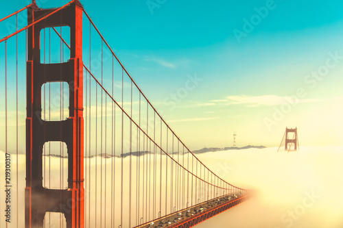 Overlook of the famous landmark the Golden Gate Bridge caught in the mist, San Francisco, California pacific coast, USA. Vintage look.