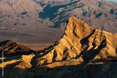 Manly Peak in Zabriskie Point on an early morning of summer, Death Valley National Park, California, USA photo