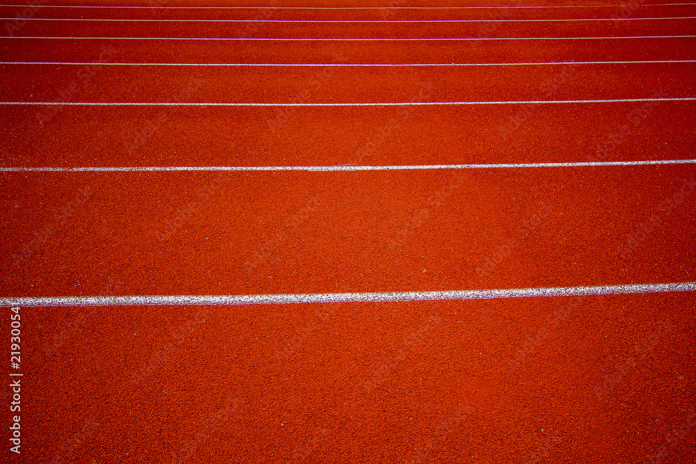 Red running track in the stadium.white line and Green lawn