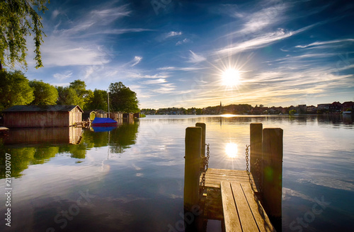 Fototapeta Naklejka Na Ścianę i Meble -  Sunset on the lake with jetty in Malchow (Mecklenburg-Vorpommern / Germany)