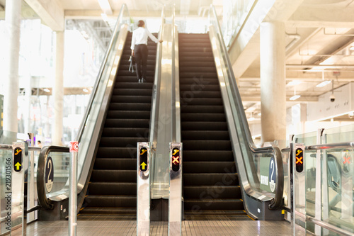 Photography Airport escalator with blurred female backpacker standing in background