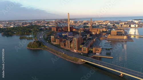 4K Aerial scene with sea, bridge, cars, power plant and sun reflections on a summer evening at sunset. Länsiväylä, Lapinlahti,Salmisaari, Ruoholahti, Helsinki, Finland, Scandinavia. photo