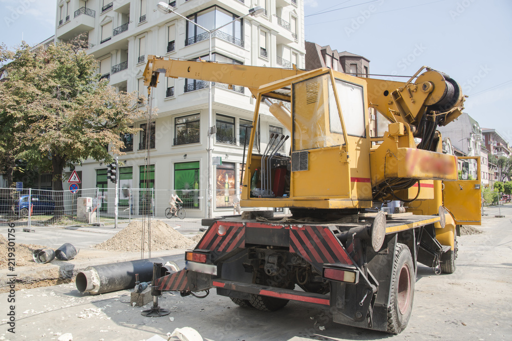Working with a crane and lifting pipes on the building Working with a crane and lifting pipes on the building
