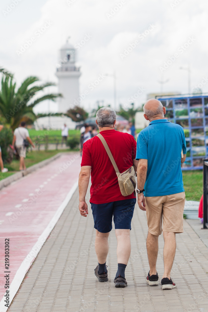 gay couple walking away together on road