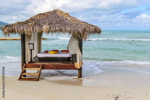 Fototapeta Naklejka Na Ścianę i Meble -  Thatch Roof Massage Hut on tropical beach in Montego Bay,