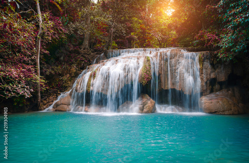 beautiful natural landscape travel of amazing waterfall in deep autumn forest with sunlight in Erawan national park at Kanchanaburi province Thailand Asia.