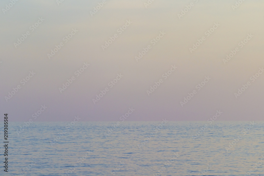 The sea at sunset, the sky in pastel colors.