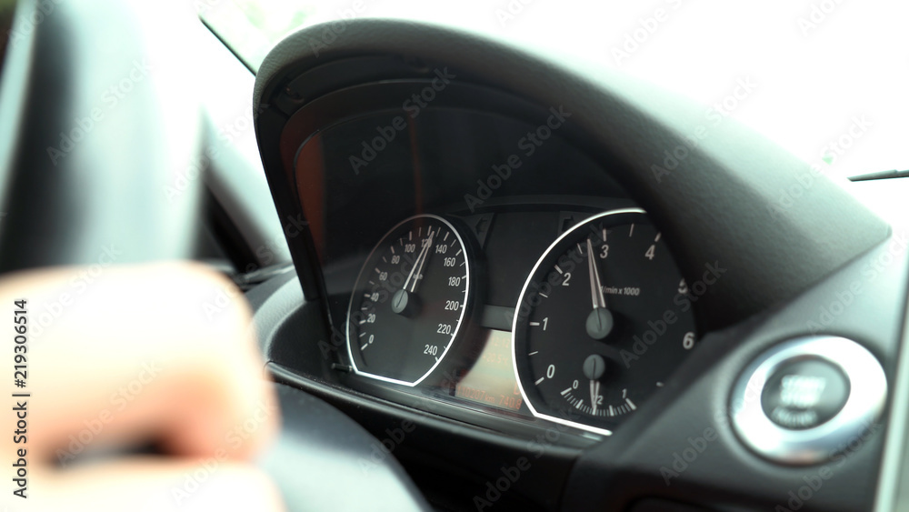 Speedometer and tachometer of car dashboard close-up