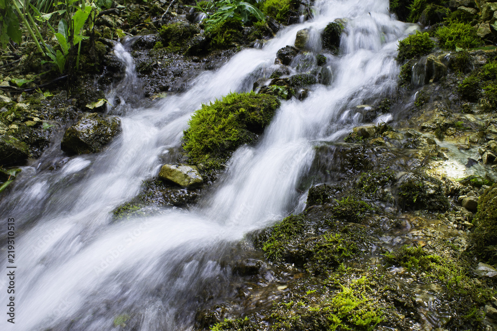 waterfall in the mountains on a long exposure waterfall in the mountains on a long exposure