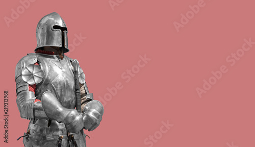 Medieval knight in shiny metal armor on a creamy background.