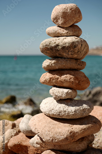 Pyramid of stones for meditation lying on sea coast
