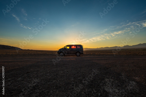 SUV in the field at sunset © serikbaib