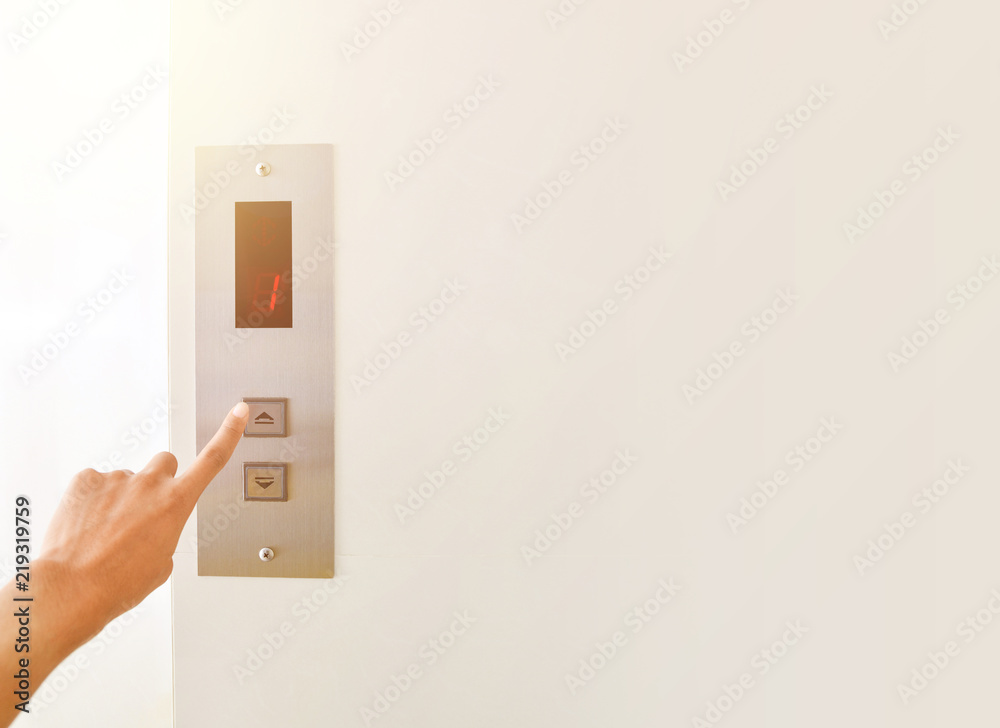 Businessman hand press open button to extend office building elevator doors with copy space Businessman hand press open button to extend office building elevator doors with copy space