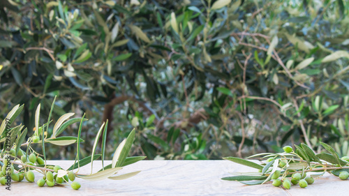 Empty stone table with blurred olive trees background with a outdoor theme. Template for display of product olive oil and olives. Background, for your photo montage.