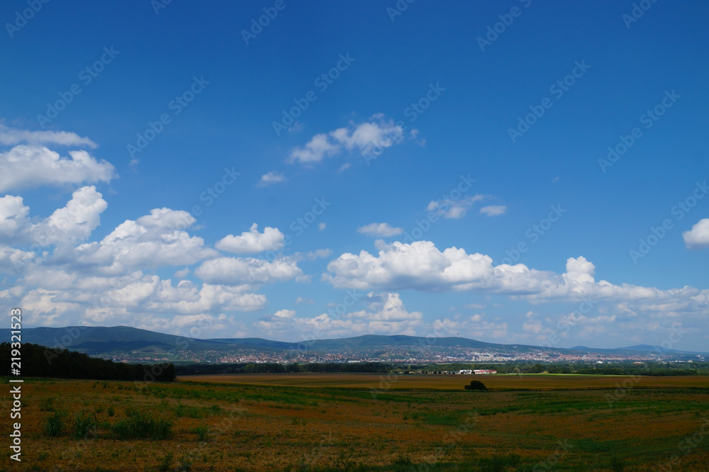 A vast landscape with sky covered with whirling clouds. Pecs city in the south of Hungary. A vast landscape with sky covered with whirling clouds. Pecs city in the south of Hungary.