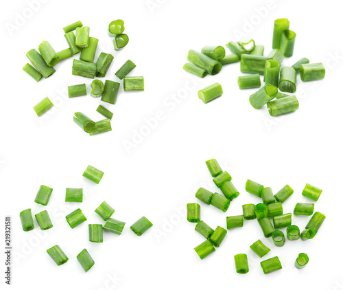 Set with cut green onion on white background