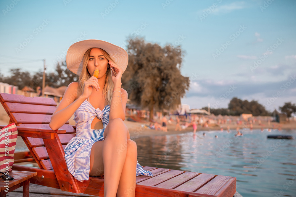 Girl talking on a phone and eating ice creeam