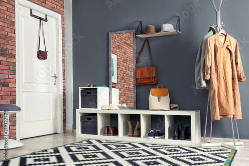 Stylish hallway interior with mirror and hanger stand photo