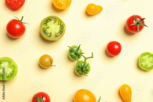 Flat lay composition with different tasty tomatoes on color background
