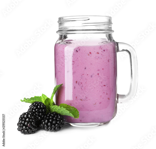 Mason jar with blackberry yogurt smoothie on white background