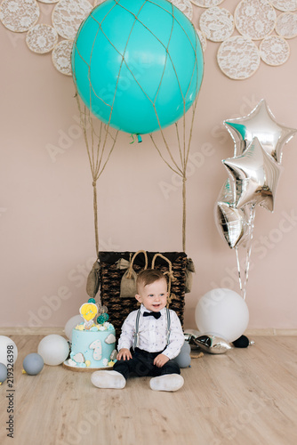 Baby's first birthday. Cute smiling baby is 1 year old. The concept of a children's party with balloons photo