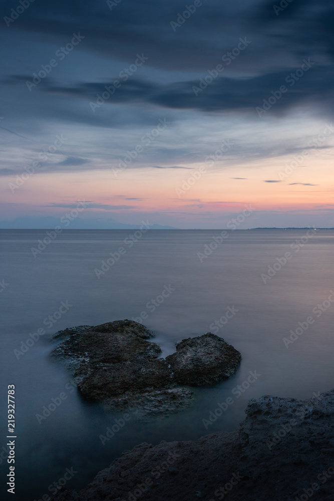 Fototapeta premium Sunset colors reflecting on the sea at Fanari beach, Komotini, Greece