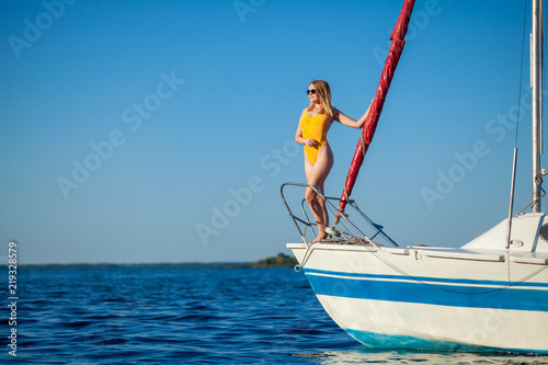 Girl standing on the bow of the yacht, sailboat. Copy space