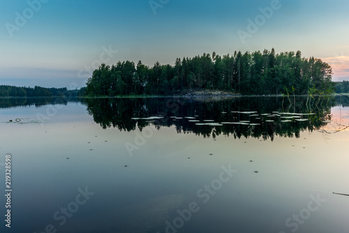 Sunset on the shores of the calm Saimaa lake in the Kolovesi National Park in Finland - 2