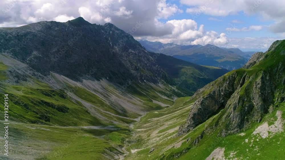 4K aerial shot approaching a valley between two mountains on top of the alps 4K aerial shot approaching a valley between two mountains on top of the alps
