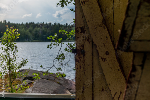 Deatil of an old wooden changing cabin on the shore of the Saimaa lake in Finland - 6 photo