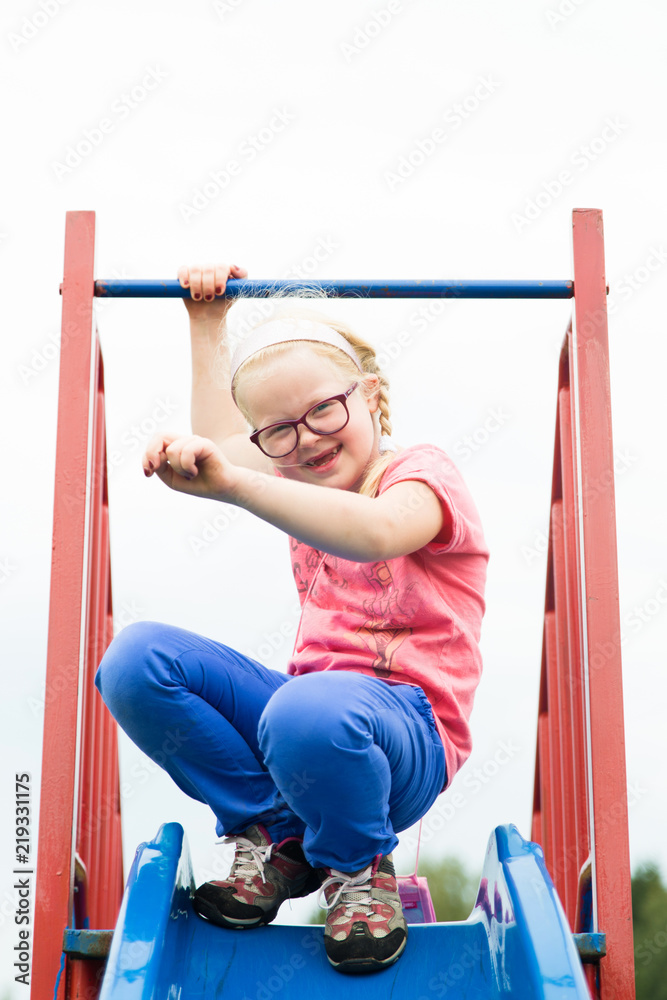 Fototapeta premium healthy childhood in the city - portrait of a cheerful active girl on a playground