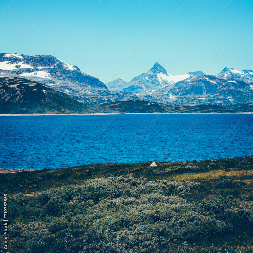 Panorama of Norwegian north countryside with Jotunheimen National Park mountains tops in the background