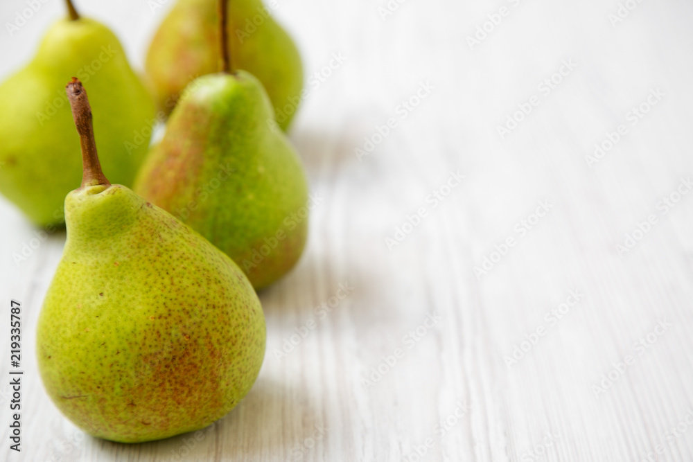 Tasty pears on a white wooden background, side view. Close-up. Copy space. Tasty pears on a white wooden background, side view. Close-up. Copy space.