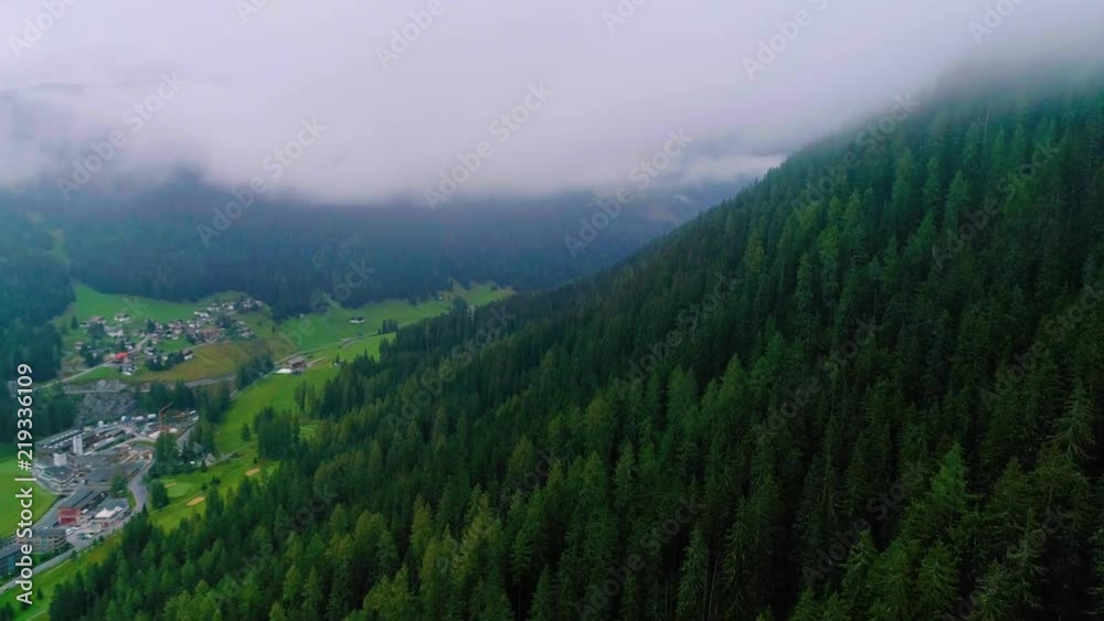4K aerial shot flying above the clouds on sunrise at a village in the alps 4K aerial shot flying above the clouds on sunrise at a village in the alps