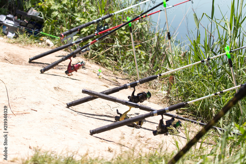 Fishing with a fishing rod on the river bank Fishing with a fishing rod on the river bank