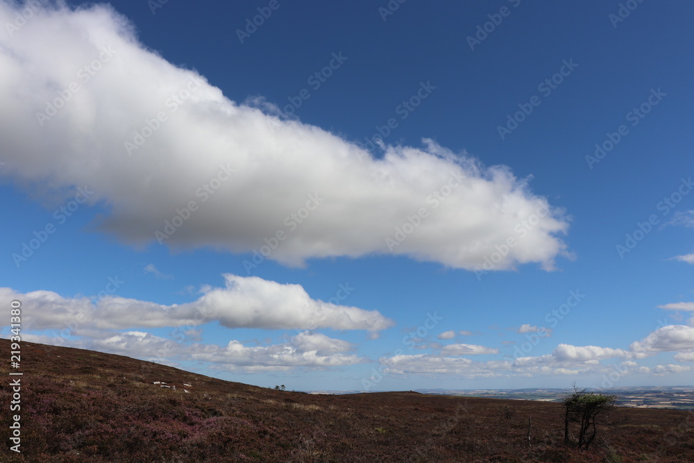Fluffy white clouds over moors Fluffy white clouds over moors