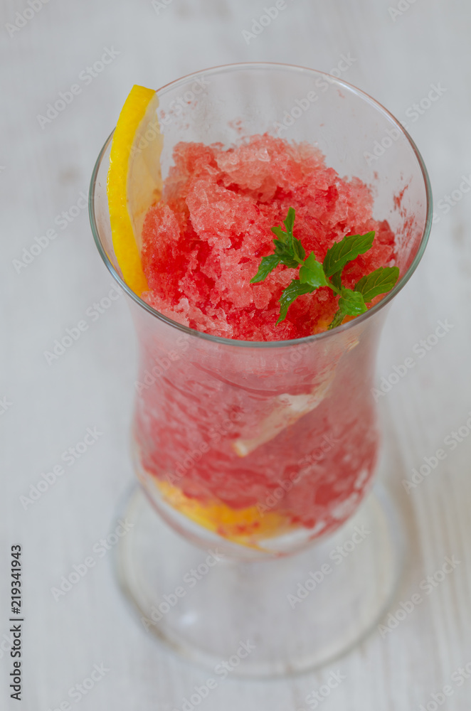 Watermelon slushie with lemon, summer refreshing drink in tall glass Watermelon slushie with lemon, summer refreshing drink in tall glass